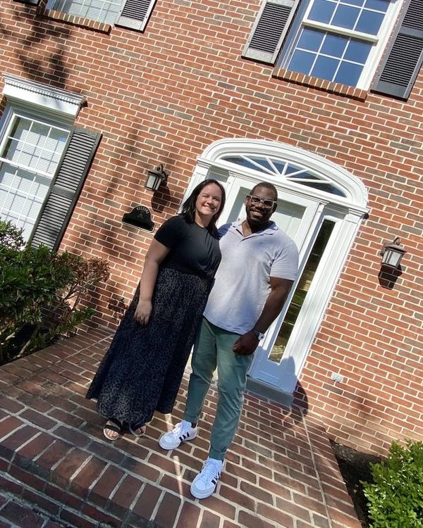 My wife and I standing in front of our new house