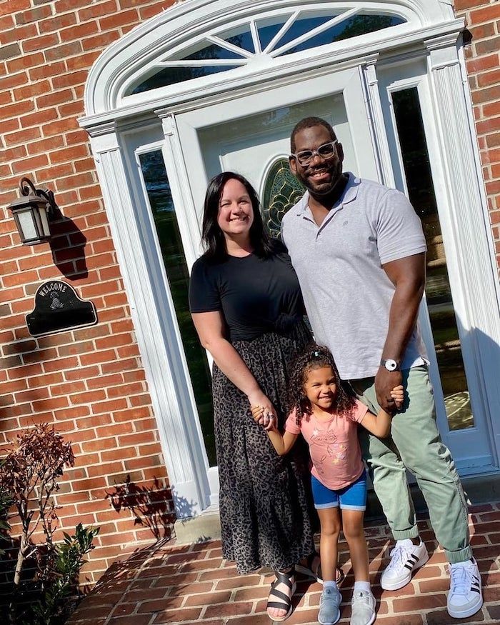 My family standing in front of our new house